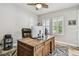 Spacious home office with wood desk, ceiling fan and natural light from two windows with plantation shutters at 4083 Woods Rider Loop, Odessa, FL 33556