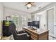 Well-lit office featuring an aquarium, plantation shutters, ceiling fan and an inviting space with natural light at 4083 Woods Rider Loop, Odessa, FL 33556