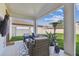 Inviting outdoor living space featuring comfortable seating, a television, and lush greenery at 4083 Woods Rider Loop, Odessa, FL 33556