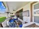 Inviting outdoor living space with comfortable seating, a ceiling fan, and views of the green lawn at 4083 Woods Rider Loop, Odessa, FL 33556