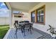 Outdoor patio featuring a dining table, chairs, grill, and a view of the fenced yard at 4083 Woods Rider Loop, Odessa, FL 33556