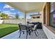 Outdoor patio featuring a dining table, chairs, grill, and a view of the fenced yard at 4083 Woods Rider Loop, Odessa, FL 33556