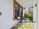 Comfortable front porch showcasing wicker seating, decorative pillows, and a welcoming atmosphere at 4083 Woods Rider Loop, Odessa, FL 33556