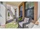 Cozy front porch with wicker seating, decorative pillows, and a green patterned rug at 4083 Woods Rider Loop, Odessa, FL 33556