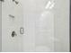 Modern shower with glass door, white subway tile, and sleek fixtures at 4083 Woods Rider Loop, Odessa, FL 33556