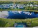 A beautiful aerial view of a home with a serene pond in the backyard and a screened-in pool at 4197 Glade Wood Loop, New Port Richey, FL 34655