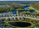 Stunning aerial view of a beautiful community with serene lakes, lush landscaping, and well-maintained homes at 4197 Glade Wood Loop, New Port Richey, FL 34655