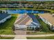 Beautiful aerial view of home with pond, solar panels, and lush landscaping at 4197 Glade Wood Loop, New Port Richey, FL 34655