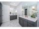 Elegant bathroom featuring double vanity, marble floors and decorative wallpaper at 4197 Glade Wood Loop, New Port Richey, FL 34655