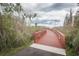Scenic boardwalk winding through lush greenery with a cloudy sky overhead for a peaceful walking experience at 4197 Glade Wood Loop, New Port Richey, FL 34655