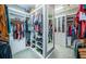 Walk-in closet with custom shelving and ample storage space for clothes and accessories at 4197 Glade Wood Loop, New Port Richey, FL 34655