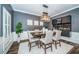 Dining room with hardwood floors, a modern chandelier and wainscoting at 4197 Glade Wood Loop, New Port Richey, FL 34655