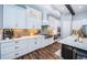 Modern kitchen with white cabinetry, stainless steel appliances and elegant backsplash at 4197 Glade Wood Loop, New Port Richey, FL 34655