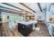 Spacious kitchen island with stone countertops, pendant lights, and ample seating at 4197 Glade Wood Loop, New Port Richey, FL 34655