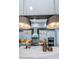 Modern kitchen featuring pendant lights, a white countertop, and stainless steel appliances at 4197 Glade Wood Loop, New Port Richey, FL 34655