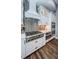 Kitchen with stainless steel stove and oven, custom backsplash, and white cabinetry at 4197 Glade Wood Loop, New Port Richey, FL 34655