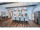 A stylish open-concept kitchen with wood flooring, a center island with seating, and modern appliances at 4197 Glade Wood Loop, New Port Richey, FL 34655