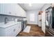 Functional laundry room with white cabinets, sink, and modern washer/dryer at 4197 Glade Wood Loop, New Port Richey, FL 34655