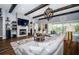 Inviting living room with a stone fireplace, beamed ceilings, and a large sectional sofa at 4197 Glade Wood Loop, New Port Richey, FL 34655