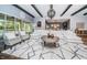 Expansive living room featuring modern decor, a large area rug, and comfortable seating at 4197 Glade Wood Loop, New Port Richey, FL 34655