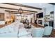 Spacious living room with cozy fireplace, modern lighting and beamed ceilings at 4197 Glade Wood Loop, New Port Richey, FL 34655