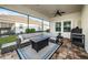 Screened patio with comfortable furniture, brick floors, a ceiling fan, and a built-in grill, making it ideal for outdoor entertaining at 4197 Glade Wood Loop, New Port Richey, FL 34655