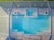 Aerial view of screened-in pool and spa with brick-paved patio area at 4197 Glade Wood Loop, New Port Richey, FL 34655