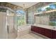 Bathroom featuring a bathtub, shower, and dual sink vanity at 4351 Mallard Lake Dr, Spring Hill, FL 34609