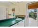 Bathroom featuring large mirror, seashell decor and access to outdoor patio at 4351 Mallard Lake Dr, Spring Hill, FL 34609