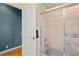 Bathroom features a shower/tub combo with glass doors, a door leading to another room, and tile flooring at 4351 Mallard Lake Dr, Spring Hill, FL 34609