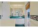 Bathroom with turquoise countertop and door that opens to pool at 4351 Mallard Lake Dr, Spring Hill, FL 34609