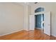 Bedroom boasts hardwood floors, neutral walls, ceiling fan, and an open doorway to another room at 4351 Mallard Lake Dr, Spring Hill, FL 34609