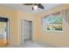 Bedroom offers a closet, ceiling fan, carpeted floors, neutral walls, and a window at 4351 Mallard Lake Dr, Spring Hill, FL 34609