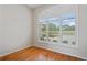 Bright bedroom features a large window with plantation shutters and hardwood floors at 4351 Mallard Lake Dr, Spring Hill, FL 34609