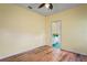 Bedroom offers laminate floors, light yellow walls, and an open doorway to another room at 4351 Mallard Lake Dr, Spring Hill, FL 34609
