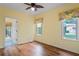 Inviting bedroom with wood flooring and a doorway to the outdoor space at 4351 Mallard Lake Dr, Spring Hill, FL 34609