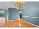Dining room with hardwood floors, chandelier, and a view of the pool at 4351 Mallard Lake Dr, Spring Hill, FL 34609