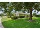 Beautifully landscaped property with mature shade trees and green lawn at 4351 Mallard Lake Dr, Spring Hill, FL 34609