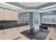 Bright kitchen featuring granite countertops, light wood cabinetry, and views of the outdoor pool at 4351 Mallard Lake Dr, Spring Hill, FL 34609