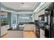 Bright kitchen featuring granite countertops, light wood cabinetry, and views of the outdoor pool at 4351 Mallard Lake Dr, Spring Hill, FL 34609