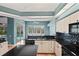 Bright kitchen featuring granite countertops, light wood cabinetry, and views of the outdoor pool at 4351 Mallard Lake Dr, Spring Hill, FL 34609