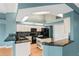Modern kitchen with an island, black appliances, granite countertops, and backsplash at 4351 Mallard Lake Dr, Spring Hill, FL 34609