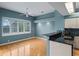 Kitchen featuring granite countertops, blue walls, tile backsplash, and wood floors at 4351 Mallard Lake Dr, Spring Hill, FL 34609