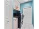Convenient laundry room featuring modern washer and dryer units with overhead cabinets at 4351 Mallard Lake Dr, Spring Hill, FL 34609