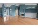 Open-concept living space with hardwood floors, a fireplace, and lots of natural light at 4351 Mallard Lake Dr, Spring Hill, FL 34609