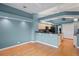 Open-concept living area with hardwood floors, granite countertops, and light blue walls at 4351 Mallard Lake Dr, Spring Hill, FL 34609