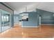 Open-concept living space with hardwood floors and a view of the screened-in pool at 4351 Mallard Lake Dr, Spring Hill, FL 34609