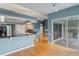 Open-concept living area with hardwood floors, granite countertops, and light blue walls at 4351 Mallard Lake Dr, Spring Hill, FL 34609
