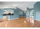 Open-concept living space with hardwood floors, adjoining the kitchen with a breakfast bar at 4351 Mallard Lake Dr, Spring Hill, FL 34609