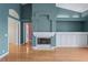 Spacious living room with hardwood floors, fireplace, and an open doorway at 4351 Mallard Lake Dr, Spring Hill, FL 34609